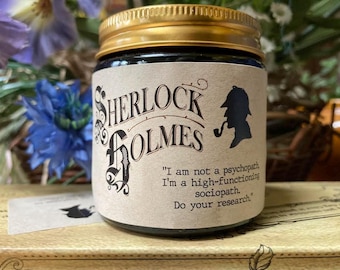 May include: A glass jar with a gold-colored screw-top lid and a beige paper label. The label features the text Sherlock Holmes, a silhouette of a detective with a pipe, and the quote: I am not a psychopath, I'm a high-functioning sociopath. Do your research.