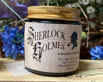 May include: A glass jar with a gold-colored metal lid and a beige paper label. The label features the text Sherlock Holmes, A Scandal in Bohemia, and the quote You see, but you do not observe. The distinction is clear, with a black silhouette icon.