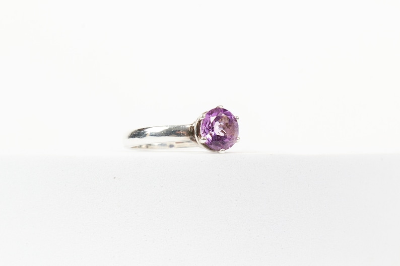 K&ouml;nnte beinhalten: Ein silberner Ring mit einem gro&szlig;en, runden, violetten Amethyst.