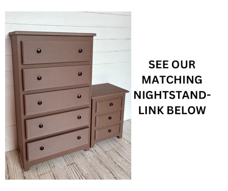 May include: A brown wooden chest of drawers with five drawers and black knobs. The chest of drawers is on a white wood floor. See our matching bedside table - link below.
