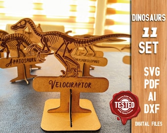 May include: A set of 11 dinosaur skeleton cutouts, each with a stand and a name tag. The dinosaurs include Velociraptor, Apatosaurus, and Parasaurolophus. The set includes digital files in SVG, PDF, AI, and DXF formats.  The image also includes the text "Dinosaurs 11 Set" and "Digital Files".