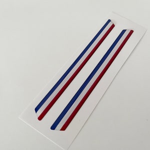 May include: Two red, white, and blue striped vinyl decals. The decals are on a white background.
