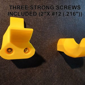 May include: Two yellow plastic wall mounts with screw holes. The text "THREE STRONG SCREWS INCLUDED (2"X #12 (.216"))" is above the mounts.