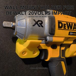 May include: A yellow and black DeWalt 20V Max XR impact driver mounted on a yellow wall mount holder. The holder has two screw holes for mounting.