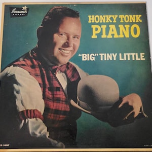 May include: Vintage vinyl record album cover featuring a smiling man in a plaid vest holding a bowler hat. The album title reads "Honky Tonk Piano" with the artist name "Big Tiny Little". The background is teal.