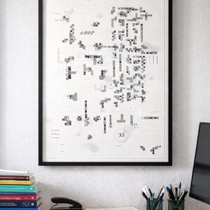 May include: A framed black and white abstract art print hangs on a white wall. The artwork features a complex arrangement of geometric shapes and numbers. The print is displayed above a desk with office supplies and books.