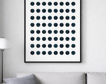 May include: Abstract art print featuring a grid of dark blue circles with teal accents, each containing a stylized design. The artwork is framed in black and hangs on a white wall above a gray sofa.