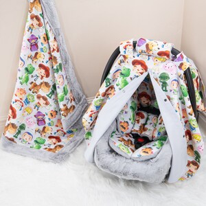 May include: A gray and white car seat cover with a Toy Story theme. The cover features a variety of Toy Story characters, including Woody, Buzz Lightyear, and Jessie. The cover is made of soft, comfortable fabric and is perfect for protecting your car seat from spills and stains.