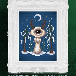 May include: A cross-stitch pattern featuring a white, one-eyed creature with antlers standing in a snowy forest under a crescent moon. The background is a dark blue with white stars.