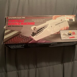 May include: A white portable electric sewing machine with accessories in a box. The box has the text "EASTERN ELECTRIC PORTABLE SEWING MACHINE with Accessories" and "Ideal for Quick Repairs and Fast Hems".
