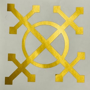 May include: Gold geometric design with a circle in the center. The design is made up of four crosses that intersect in the center. The circle is also divided into four sections by the crosses.