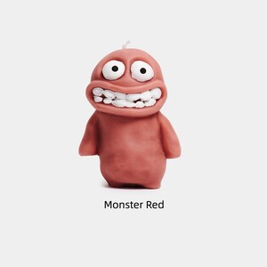 May include: A red monster candle with a wide smile and large eyes. The candle is made of wax and has a simple design.