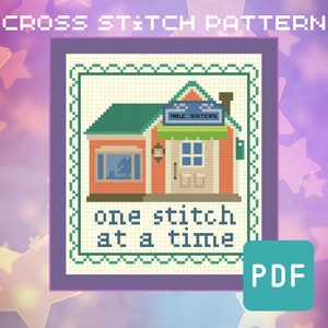 May include: Cross stitch pattern featuring a small house with a sign that reads "Able Sisters" and the text "one stitch at a time".