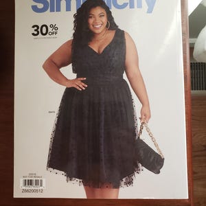 May include: A Simplicity sewing pattern magazine cover featuring a woman in a black polka dot dress. The magazine has the Simplicity logo and text indicating a 30% discount. The woman is holding a black purse with a gold chain.