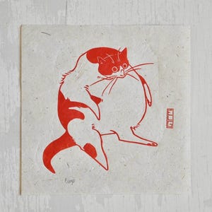 May include: Red and white illustration of a cat printed on a cream-colored paper. The cat is sitting with its back to the viewer and its head turned to the side. The cat's tail is curled around its body. The image is signed "Bing" in the bottom left corner.