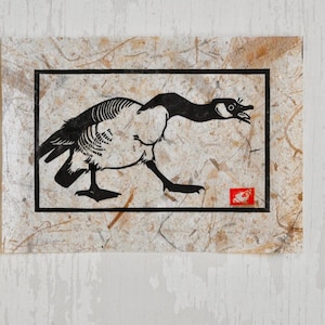 May include: A black and white illustration of a goose with its head turned to the side, printed on a textured paper background.