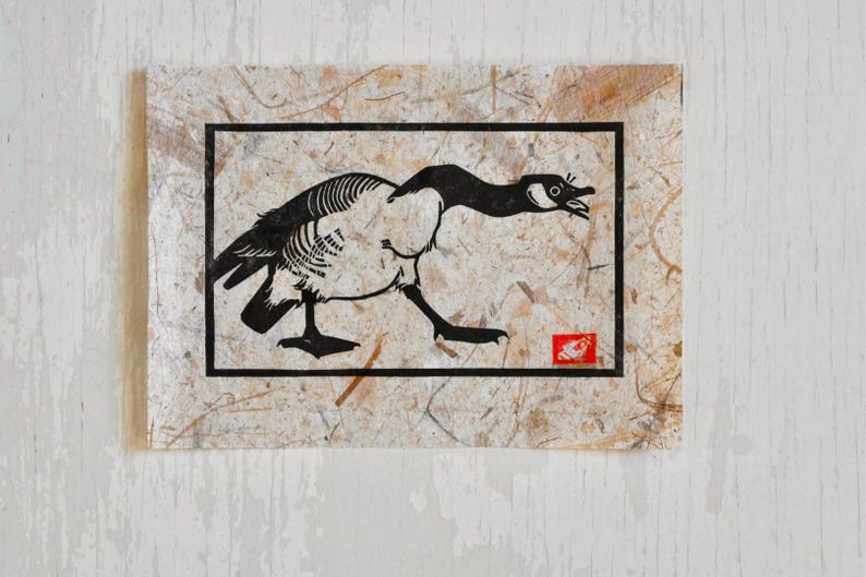 May include: A black and white illustration of a goose with its head turned to the side, printed on a textured paper background.