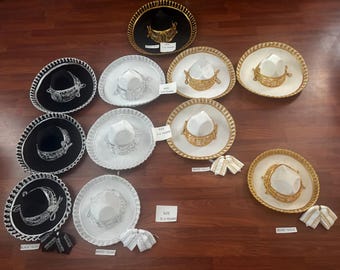 May include: A collection of ten sombreros arranged in rows, featuring black, white, and beige felt bases with intricate metallic silver or gold embroidery along the brims and crowns. Each hat includes a matching bow tie accessory.