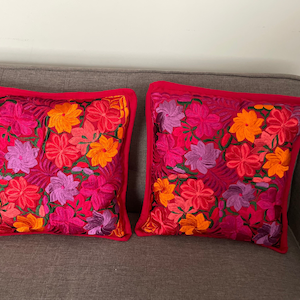Two decorated covers embroidered with typical Mexican motifs.