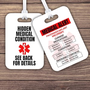 May include: Two white medical alert tags with clear plastic loops. One tag reads "HIDDEN MEDICAL CONDITION" with a red medical symbol and "SEE BACK FOR DETAILS." The other tag says "MEDICAL ALERT" and lists medications, conditions, and emergency contacts.