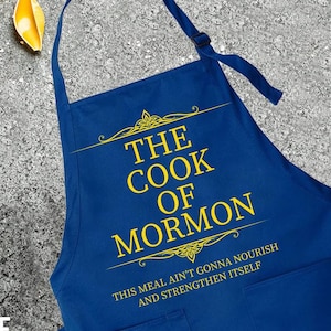 May include: A royal blue apron with yellow text that reads "The Cook of Mormon. This meal ain't gonna nourish and strengthen itself."