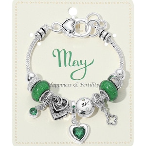 May include: Silver charm bracelet with green beads and heart-shaped charms. The bracelet includes a charm with the word "May" and the phrase "Happiness & Fertility". A clover charm and a green gem are also included.