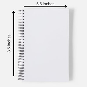 May include: A white spiral bound notebook with a white cover. The notebook measures 8.5 inches by 5.5 inches.