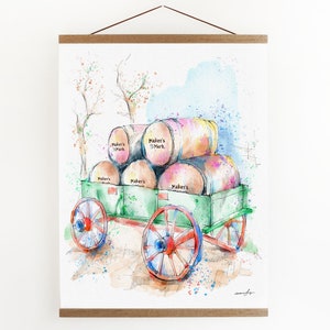 May include: A watercolor painting of a green wooden wagon carrying stacked barrels labeled "Maker's Mark". The wagon has red wheels and is set against a light blue and white background with splashes of color.
