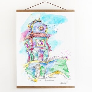 May include: Watercolor painting of a colorful clock tower with a blue dome and green accents. The tower is set against a light blue sky with pink and white watercolor splatters.