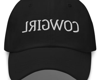 May include: Black baseball cap with white embroidered text that reads "COWGIRL" backwards.