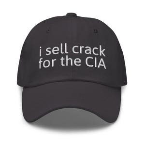 May include: A black baseball cap with white embroidered text that reads "i sell crack for the CIA".