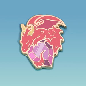 May include: A red and pink dragon pin with gold accents, resting on a purple and pink crystal. The dragon has a relaxed pose with closed eyes. The pin is set against a light blue background.