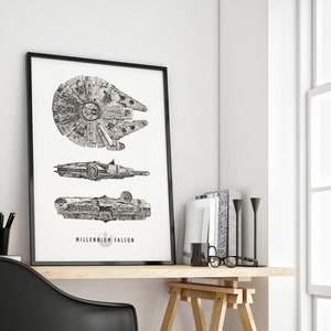 May include: A black and white line drawing of the Millennium Falcon spaceship in three different views. The drawing is framed in a black frame and hanging on a white wall.