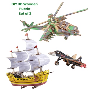 May include: A set of three DIY 3D wooden puzzles: a helicopter with camouflage design, a sailboat with white sails and red flags, and a black jet with the text "SU-30". The puzzles are made of light brown wood.
