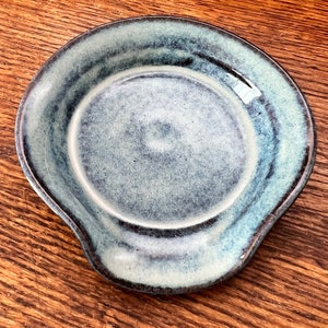 Spoon rest: Handmade, hand glazed with light/dark blue glaze over brown stoneware.  Food safe, microwave & dishwasher safe. Artist signed