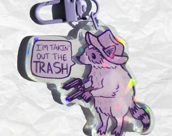 Brelok do kluczy z motywem szopa pracza „Takin' Out the Trash”, holograficzny akrylowy, zabawny prezent