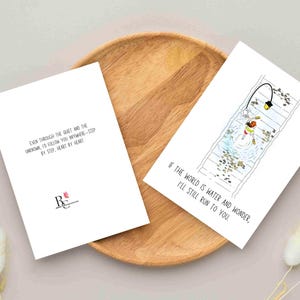 Greetings card with an illustration of Chihiro from Spirited away, Ghibli movie. She is running on rail tracks, which are under water, along with a walking street lamp. The card has a minimalist vibe with a phrase under the image that says " If the world is water and wonder, I will still run to you". The back of the card also has a phrase that says " Even through the quiet and the unknown, I'd follow you anywhere- step by step, heart by heart". It is a Studio Ghibli fan art greetings card.