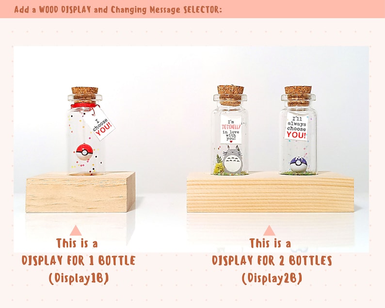 May include: Two wooden display stands for small glass bottles. The stand on the left holds one bottle with a red and white Pokeball inside. The stand on the right holds two bottles, one with a Totoro character inside and the other with a Pokeball inside. The text on the stands reads "This is a DISPLAY FOR 1 BOTTLE (Display16)" and "This is a DISPLAY FOR 2 BOTTLES (Display26)".