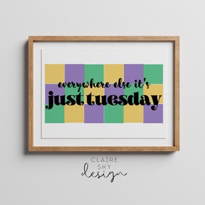 May include: A framed print with a colorful checkered background and the text "everywhere else it's just tuesday". The print is in a wooden frame and has the text "CLAIRE SKY design" at the bottom.