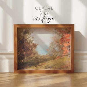 Puede incluir: Una pintura enmarcada de un paisaje con &aacute;rboles y un cielo azul. La pintura est&aacute; en un marco de madera y tiene un aspecto vintage. El texto "CLAIRE SKY vintage" est&aacute; impreso en el marco.