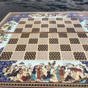 May include: A detailed, hand-painted chess and backgammon board. The board features a checkerboard pattern with alternating black and tan squares. The border is adorned with intricate illustrations of figures in traditional attire, set against a blue background.