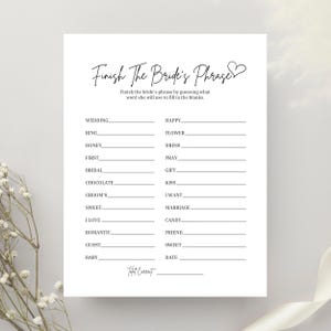 May include: A printable bridal shower game called "Finish the Bride's Phrase". The game features a list of words on the left side and a blank line on the right side for guests to complete the phrase.