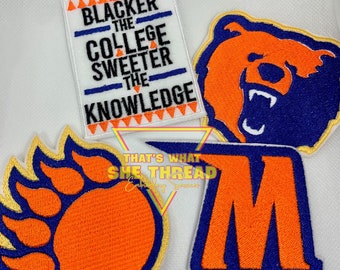 May include: Four embroidered patches with orange and blue colors. The patches feature a bear, a paw print, the letter "M", and the text "Blacker the College Sweeter the Knowledge".