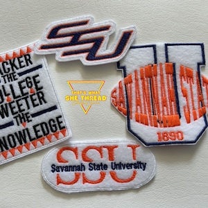 May include: Four embroidered patches featuring the Savannah State University logo. The patches are white with orange and blue embroidery. One patch features the text "Blacker the College Sweeter the Knowledge" with a black and white color scheme.
