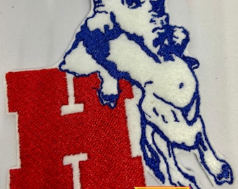 Può includere: Toppa ricamata con un bufalo bianco con contorni blu, in piedi sulla lettera rossa "H". La toppa ha un bordo bianco e il testo "That's What She Thread" in un triangolo colorato sotto.