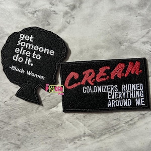 May include: Two black embroidered patches. The first patch features a black silhouette of a woman's head with the text "get someone else to do it. -Black Women". The second patch features the text "CREAM COLONIZERS RUINED EVERYTHING AROUND ME" in red and white embroidery.