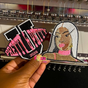 May include: A white ceramic mug with a black handle and the text "But First, Coffee" in a black, handwritten-style font. The mug is on a white surface.