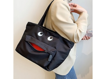 Black Nylon Large Capacity Tote Bag with Three Pockets Shoulder Straps and Novelty Eyes and Lip Design