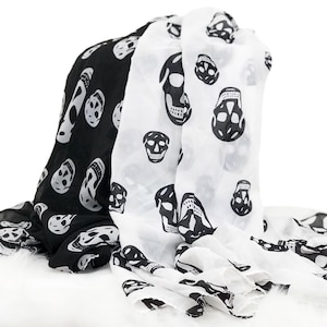May include: A black and white scarf with a skull pattern. The scarf is made of a lightweight fabric and is perfect for adding a touch of style to any outfit.