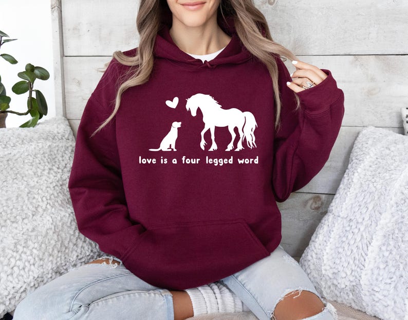 May include: A maroon hoodie with a white graphic of a horse and a dog with the text "love is a four legged word".